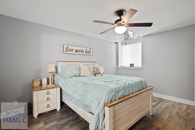 226 Topi Trl, Hinesville, GA 31313 - bedroom with dark wood-type flooring, a textured ceiling, baseboards, and a ceiling fan