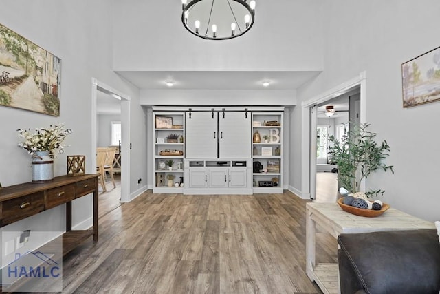 226 Topi Trl, Hinesville, GA 31313 - foyer with a high ceiling, light wood-style floors, healthy amount of natural light, a chandelier, and baseboards
