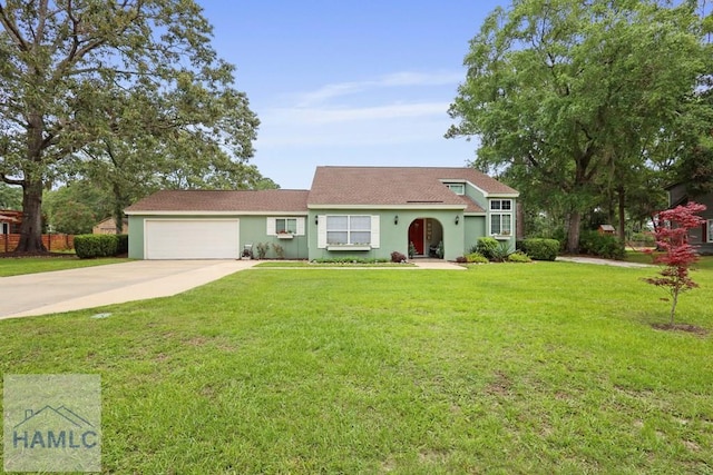 226 Topi Trl, Hinesville, GA 31313 - view of front of home featuring stucco siding, driveway, an attached garage, and a front yard
