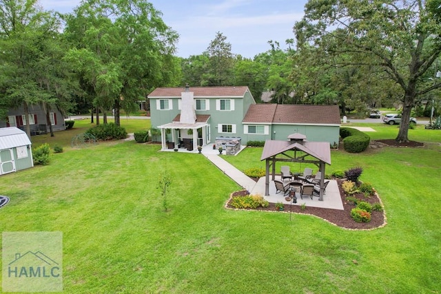 226 Topi Trl, Hinesville, GA 31313 - rear view of house with a gazebo, a patio area, a lawn, and stucco siding