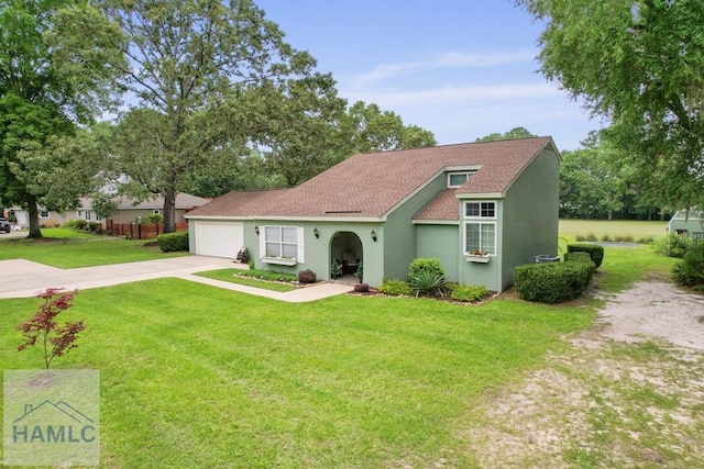 226 Topi Trl, Hinesville, GA 31313 - view of front facade featuring concrete driveway, an attached garage, a front yard, and stucco siding