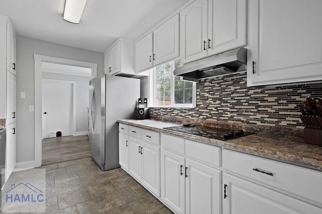 226 Topi Trl, Hinesville, GA 31313 - kitchen featuring under cabinet range hood, freestanding refrigerator, black electric cooktop, and tasteful backsplash