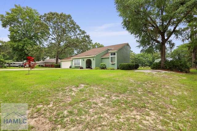 226 Topi Trl, Hinesville, GA 31313 - view of green lawn featuring a garage