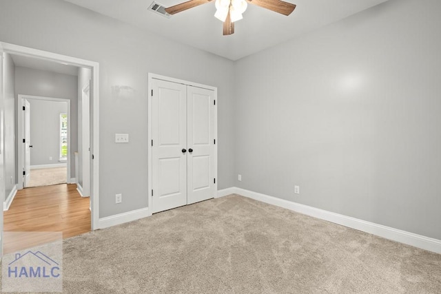 88 Windy Oaks Ct, Midway, GA 31320 - unfurnished bedroom with light carpet, a closet, and a ceiling fan