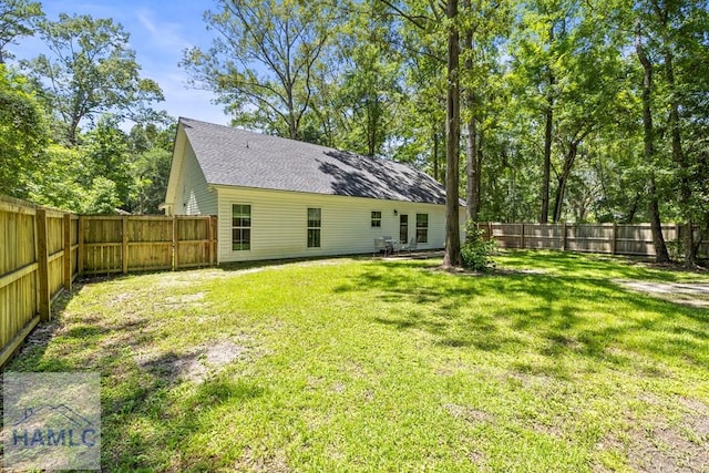 88 Windy Oaks Ct, Midway, GA 31320 - back of house featuring a fenced backyard and a shingled roof