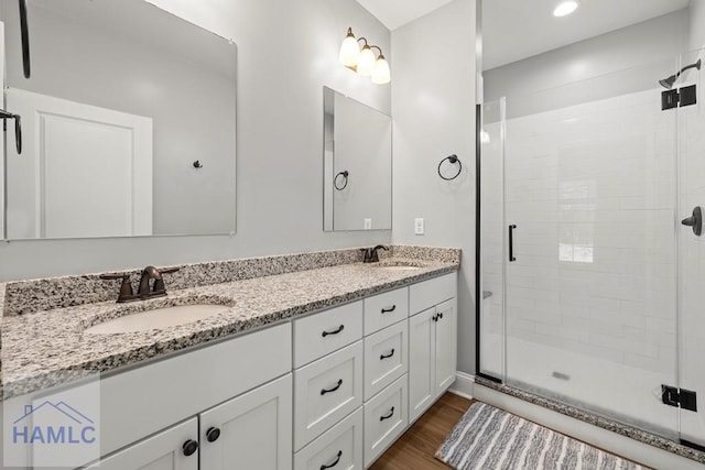 88 Windy Oaks Ct, Midway, GA 31320 - bathroom with a shower stall, double vanity, and wood finished floors