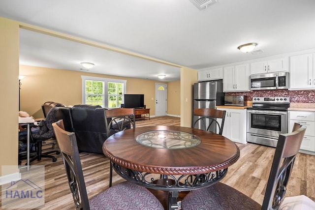 1869 Freedman Grove Rd, Fleming, GA 31309 - dining space with light wood-style flooring