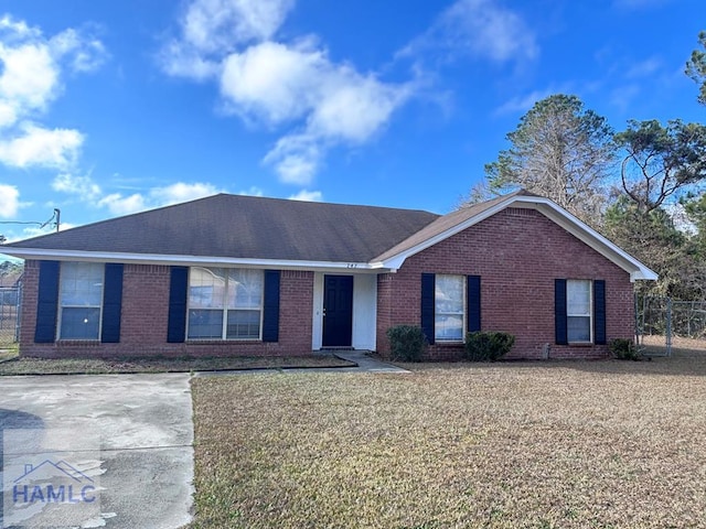 ranch-style home with a front lawn