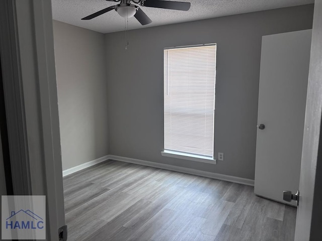 unfurnished room featuring ceiling fan, a textured ceiling, and a wealth of natural light