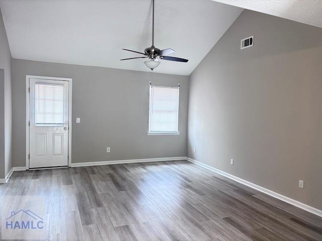 unfurnished room featuring hardwood / wood-style floors, ceiling fan, and vaulted ceiling