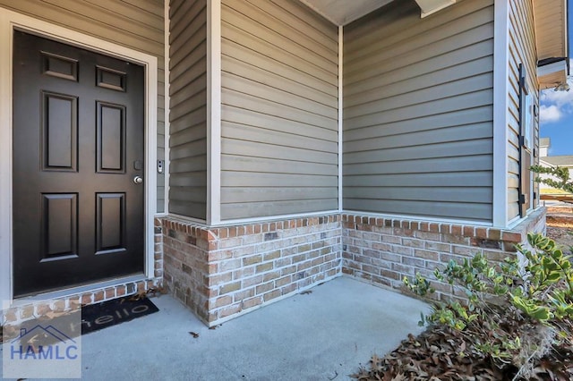 property entrance featuring brick siding