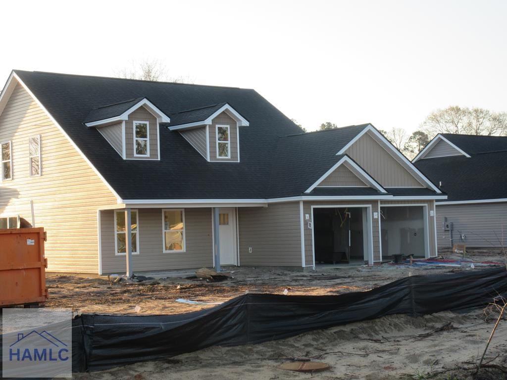 view of front of property with roof with shingles