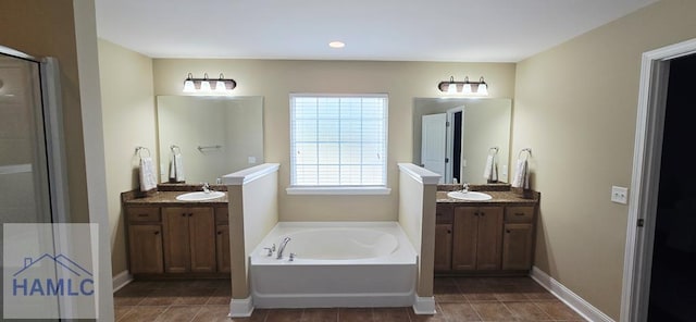 14 Cantebury Rd, Ludowici, GA 31316 - bathroom featuring a garden tub, two vanities, tile patterned flooring, and a shower stall