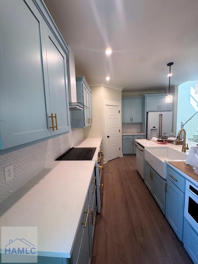 43 Belle Island Way, Richmond Hill, GA 31324 - kitchen with white appliances, wall chimney range hood, dark wood-style flooring, hanging light fixtures, and light countertops