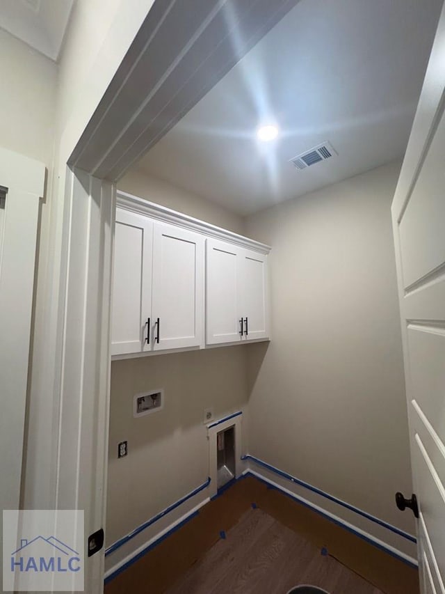 43 Belle Island Way, Richmond Hill, GA 31324 - washroom featuring cabinet space, hookup for a washing machine, hookup for an electric dryer, and dark wood-style flooring