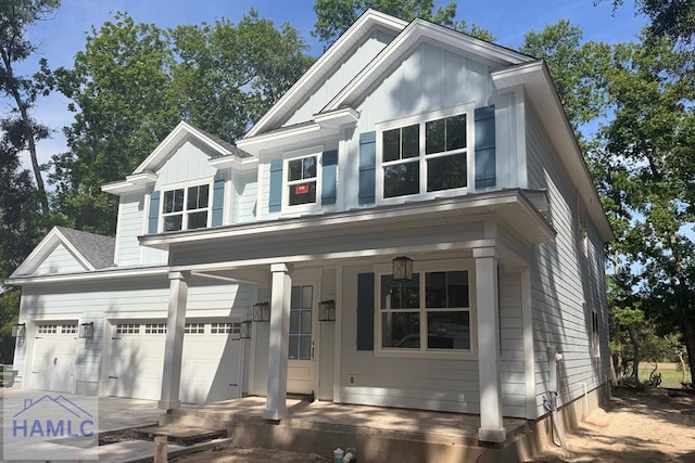 43 Belle Island Way, Richmond Hill, GA 31324 - view of front of house featuring a porch, an attached garage, board and batten siding, and concrete driveway