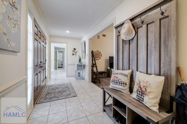 interior space featuring crown molding and light tile patterned flooring