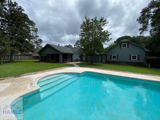 view of pool with a yard and a patio