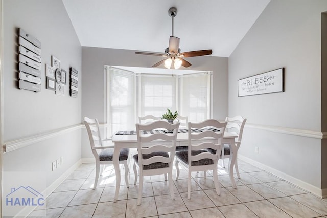 dining room with light tile patterned floors, ceiling fan, and lofted ceiling