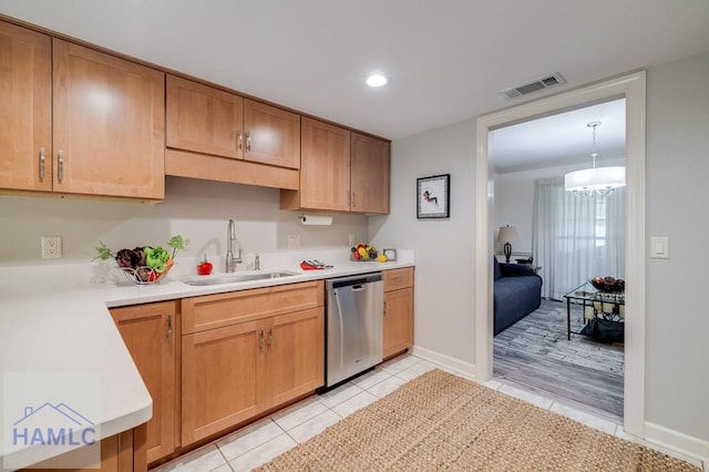 kitchen with dishwasher, sink, hanging light fixtures, light hardwood / wood-style floors, and a chandelier