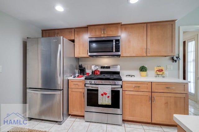 kitchen with light tile patterned floors and appliances with stainless steel finishes