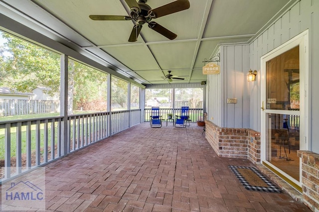 unfurnished sunroom with ceiling fan