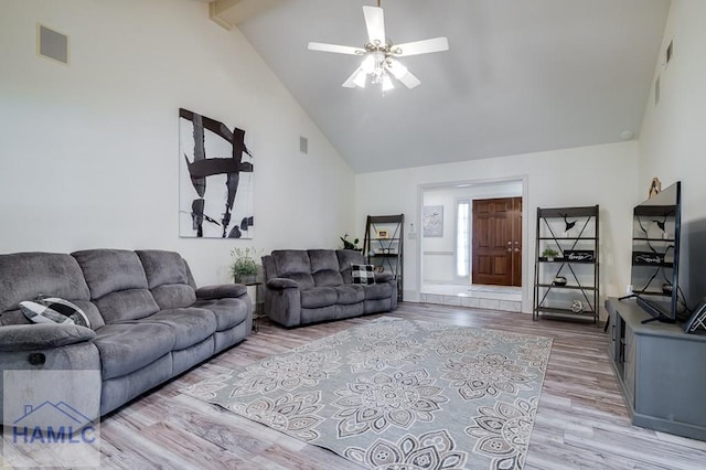 living room featuring ceiling fan, beam ceiling, high vaulted ceiling, and light hardwood / wood-style flooring