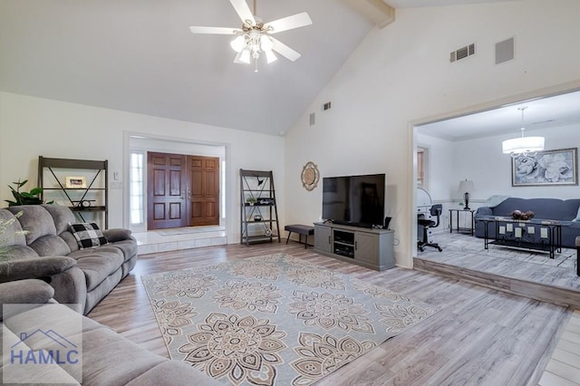 living room featuring beam ceiling, light wood-type flooring, high vaulted ceiling, and ceiling fan