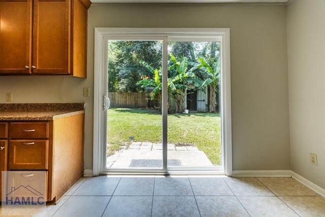 doorway to outside with light tile patterned floors