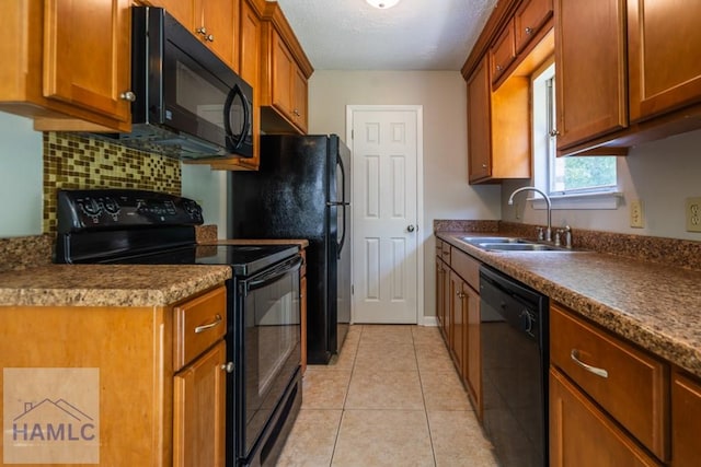 kitchen featuring decorative backsplash, sink, light tile patterned flooring, and black appliances