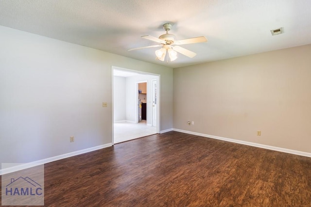 spare room with dark hardwood / wood-style floors and ceiling fan