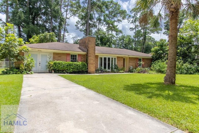 single story home with a front yard and french doors