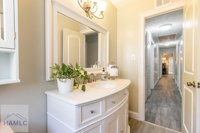 375 Eastridge Rd, Savannah, GA 31406 - bathroom featuring hardwood / wood-style floors, vanity, and a notable chandelier