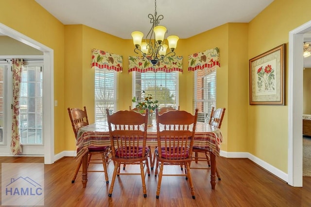 dining room with a notable chandelier and hardwood / wood-style flooring