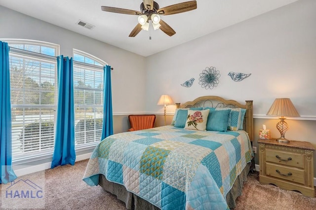 bedroom featuring light carpet and ceiling fan