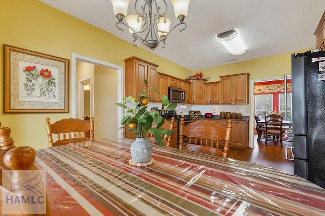 dining room with a notable chandelier and dark hardwood / wood-style flooring