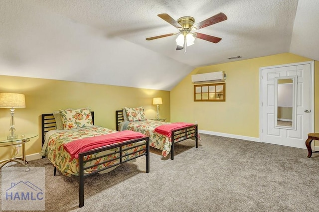 bedroom featuring lofted ceiling, an AC wall unit, a textured ceiling, and carpet