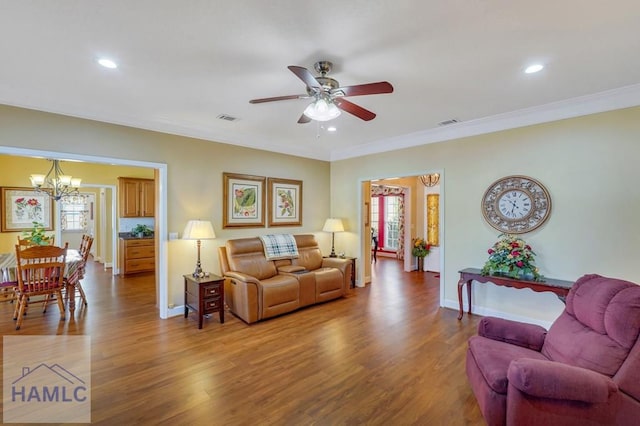 living room with crown molding, a healthy amount of sunlight, and hardwood / wood-style floors