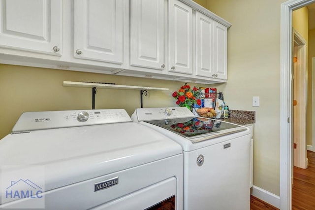 laundry area with cabinets and washing machine and dryer