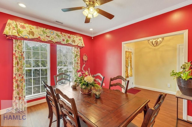 dining room with ornamental molding, hardwood / wood-style floors, and ceiling fan