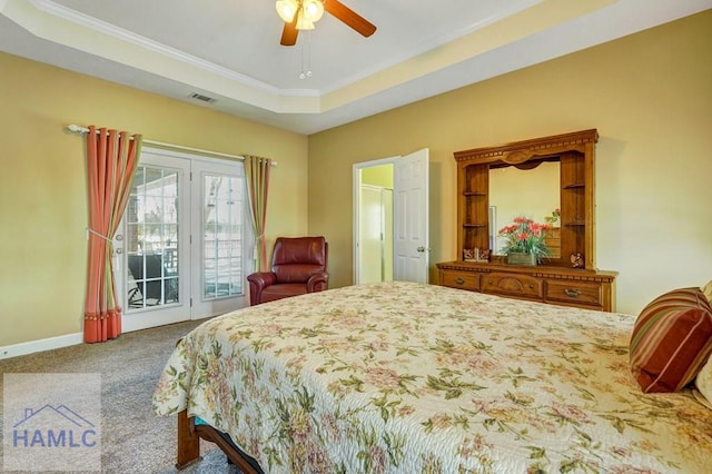 carpeted bedroom with ceiling fan, ornamental molding, a tray ceiling, and access to exterior