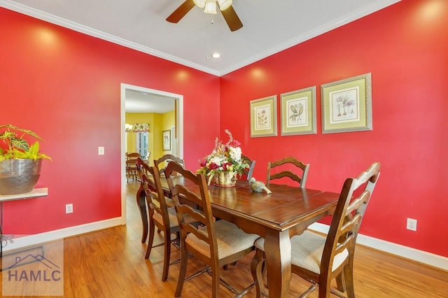 dining area featuring hardwood / wood-style flooring, crown molding, and ceiling fan