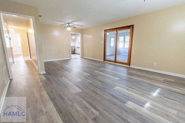 unfurnished living room with ceiling fan and wood-type flooring