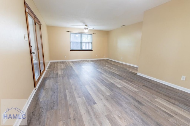 spare room featuring wood-type flooring and ceiling fan