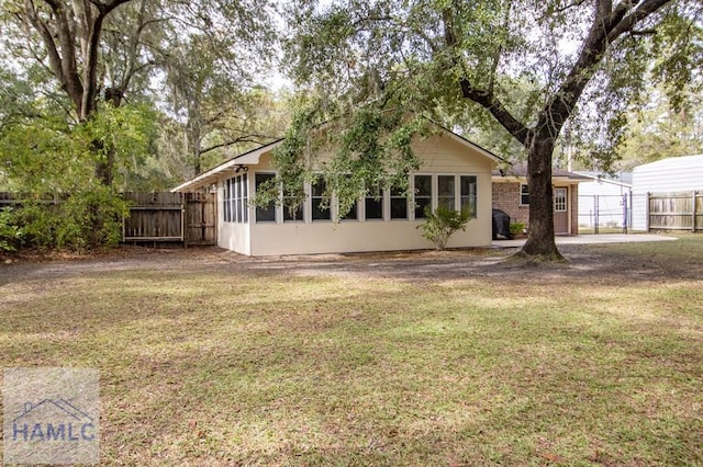 rear view of house featuring a yard