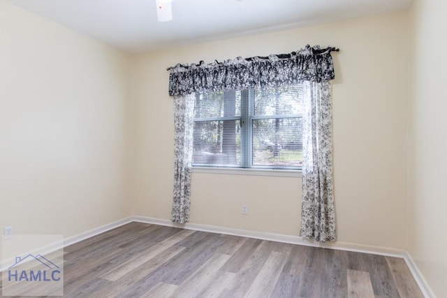 spare room with wood-type flooring