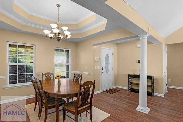 365 Carson St NE, Ludowici, GA 31316 - dining area with ornate columns, a chandelier, wood finished floors, ornamental molding, and a tray ceiling