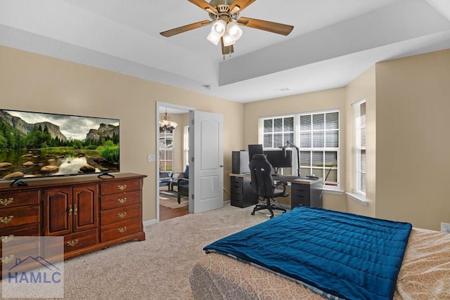 365 Carson St NE, Ludowici, GA 31316 - carpeted bedroom with a desk, a ceiling fan, a tray ceiling, and baseboards