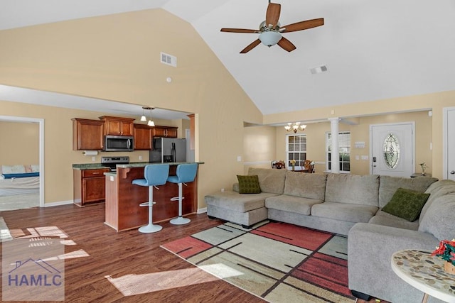 365 Carson St NE, Ludowici, GA 31316 - living room featuring high vaulted ceiling, a chandelier, dark wood-style flooring, a ceiling fan, and baseboards