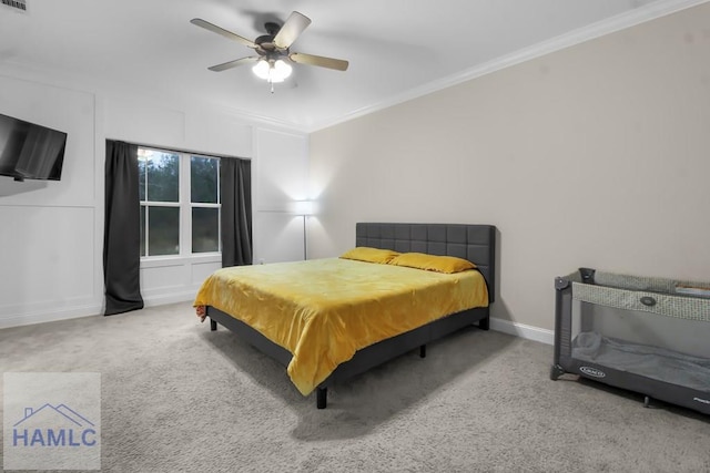 carpeted bedroom featuring ornamental molding and ceiling fan